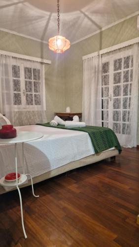 a bedroom with a bed and a chandelier at Nicolas Dream in Nea Makri