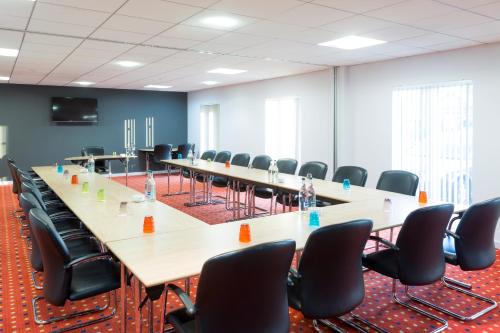a large conference room with a long table and chairs at ibis Styles Haydock in Haydock