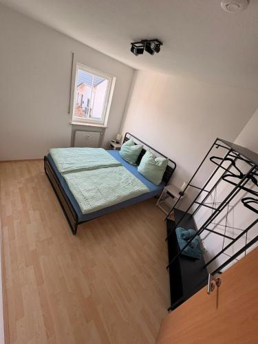 a bedroom with a bed with blue sheets and a window at InSight Luxury Bavarian Retreat in Kemnath