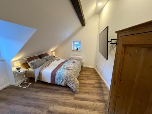 a bedroom with a large bed in a attic at Am Hirtenturm, anno 1397, auf der Quelle der Ahr in Blankenheim