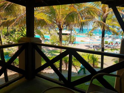 a view from a window of a resort with palm trees at Catussaba Resort Hotel in Salvador