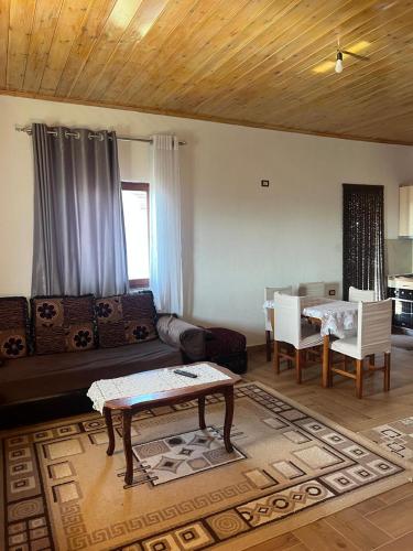 a living room with a couch and a table at Bert-House close to the sea in Lezhë