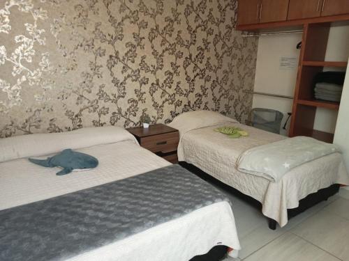 a room with two beds and a stuffed animal on the bed at Casa SOL #222, para 6 personas in La Paz