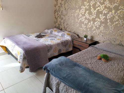 a bedroom with two beds and a stuffed animal on the bed at CASA LUNA , para 6 personas in La Paz