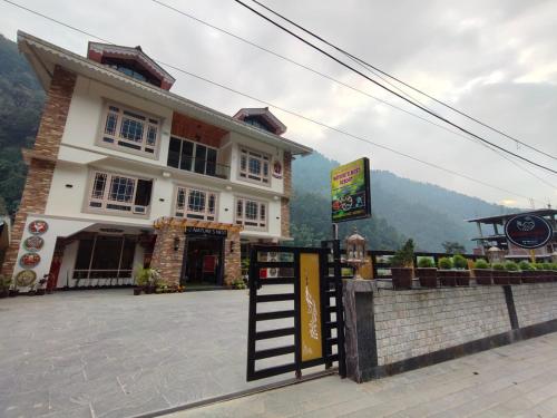 a building with a sign in front of it at Nature's Nest Resort in Rongli