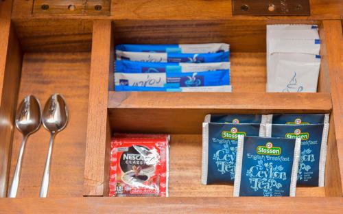 a drawer with utensils and a box of food at Tea Hills Ella in Ella