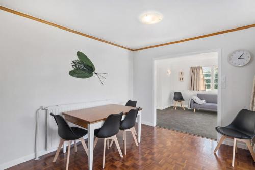 a dining room with a table and chairs at Thermal Adventure Retreat in Rotorua