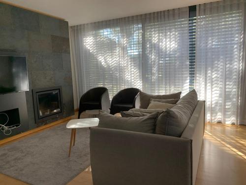 a living room with a couch and a fireplace at Summer Villa in Troia