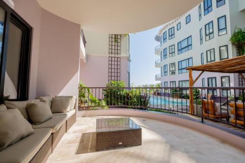 a living room with a couch and a balcony at Diamante Beachfront Suites in San Pedro