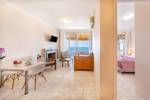 a living room with a view of the ocean at Lido Sofia Apartments in Agios Gordios