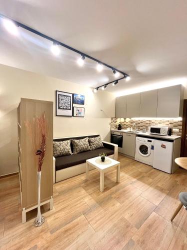 a living room with a couch and a table at Salt Lake Studio in Pomorie