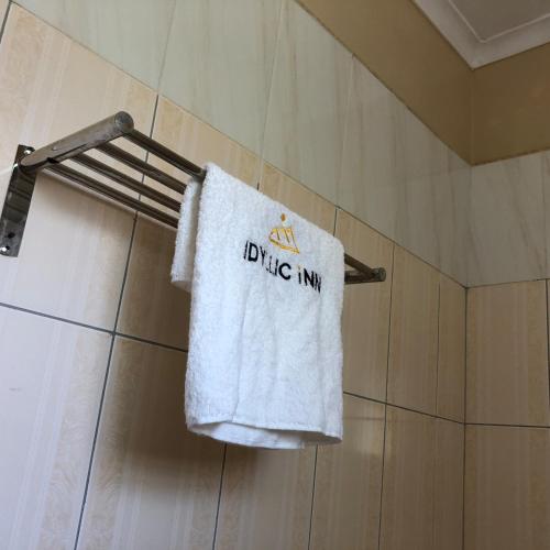 a towel hanging on a towel rack in a bathroom at Idyllic Inn in Lilongwe