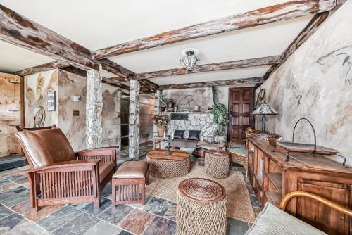 a living room with a stone wall at Terracana Ranch Resort in Tete Jaune Cache