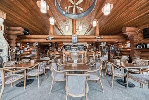 a restaurant with wooden walls and tables and chairs at Terracana Ranch Resort in Tete Jaune Cache