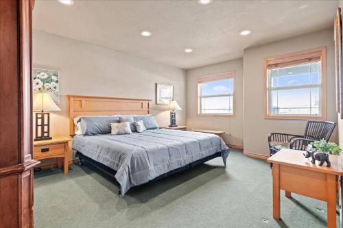 a bedroom with a bed and a desk and a chair at Cozy 2.4 in Hayden