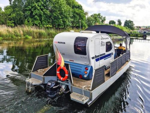 a small boat with a trailer on the water at Houseboat on the Peene in Demmin in Verchen