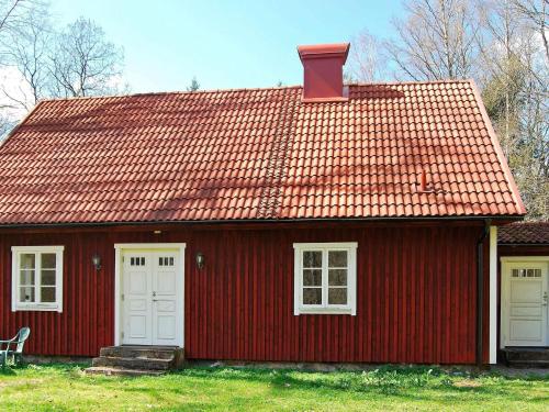 a red house with white doors and a red roof at 7 person holiday home in VANKIVA-By Traum in Vankiva