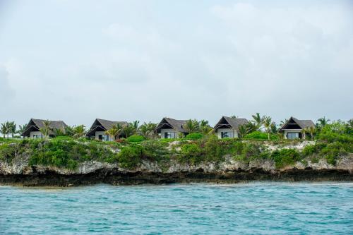 a row of houses on an island in the water at Zawadi Hotel, Zanzibar in Michamvi