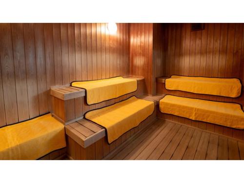 a sauna with yellow seats in a wooden room at Le Nessa Akazawa - Vacation STAY 03714v in Futo