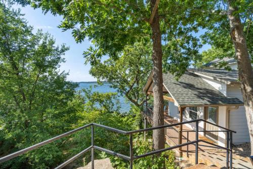 a home with a staircase leading up to a house with trees at CrossTimbers Marina and Cottages in Sperry