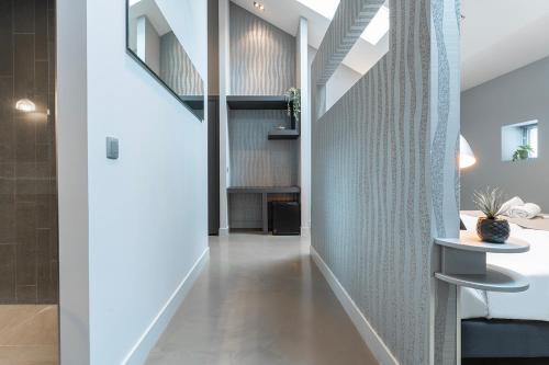 a hallway of a house with a staircase and a table at Suite With Wellness Nextdoor And Kitchen Access in Oss