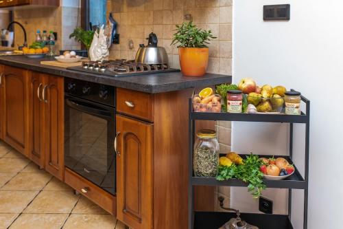 a kitchen with a counter with fruits and vegetables on shelves at Agroturystyka Świętego Józefa in Chrzypsko Wielkie