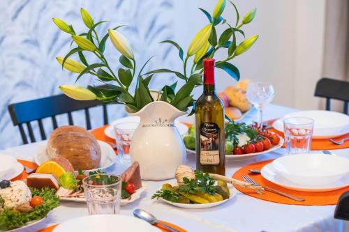 a table with a bottle of wine and food on it at Agroturystyka Świętego Józefa in Chrzypsko Wielkie