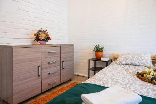 a bedroom with a bed and a dresser with fruit on it at Agroturystyka Świętego Józefa in Chrzypsko Wielkie
