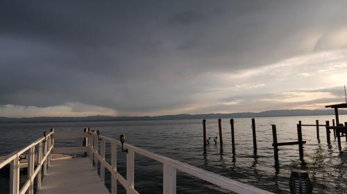 a dock on a body of water with a cloudy sky at Modern Waterfront Home in Lucerne in Lucerne
