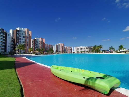 a boat sitting on the side of a body of water at Dreams Lagoon in Cancún