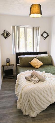 a bedroom with a large bed and a large window at 4 beds spacious Apartment, with Parking & WIFI, CHAFFORD HUNDRED, near station & shopping, long stays! in West Thurrock