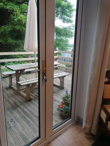 a sliding glass door with a view of a deck at Ben Levy House Rental Suite, Clonbur Village in Clonbur