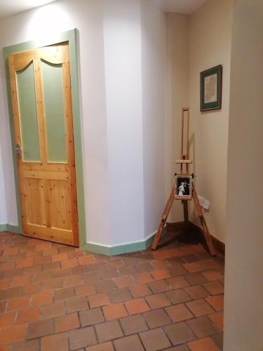 a room with a wooden door and a tripod at Ben Levy House Rental Suite, Clonbur Village in Clonbur