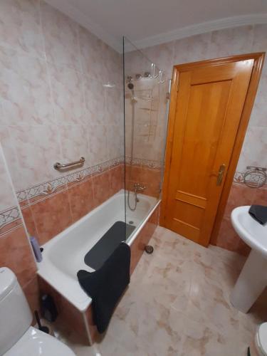 a bathroom with a shower and a tub and a sink at Pinada Golf Apartment in Orihuela Costa