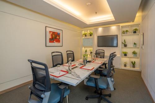 a conference room with a long table and chairs at Hyatt Centric MG Road Bangalore in Bengaluru