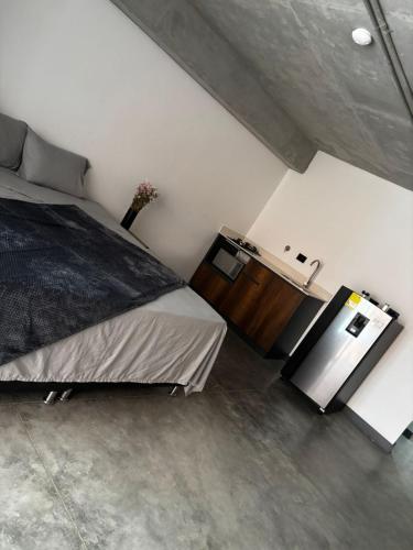 a bedroom with a large bed and a wooden dresser at Encantador Loft urbano en el corazón de Medellín in Medellín