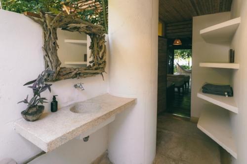 a bathroom with a sink and a mirror on the wall at Isla Fuerte Eco House in Isla Fuerte