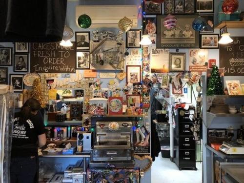 a woman is standing in a store with a counter at In the clouds your cozy- lake house in Swan Lake