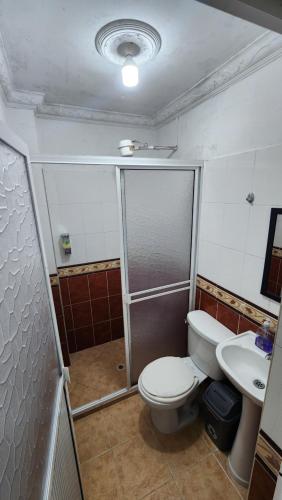 a bathroom with a toilet and a shower and a sink at Apartamento Acogedor - San Luis, Ant - Shelter La Perla Hostal in San Luis