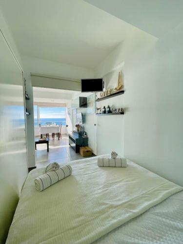 a bedroom with a large bed with a view of the ocean at Acqua Marine in Sesimbra