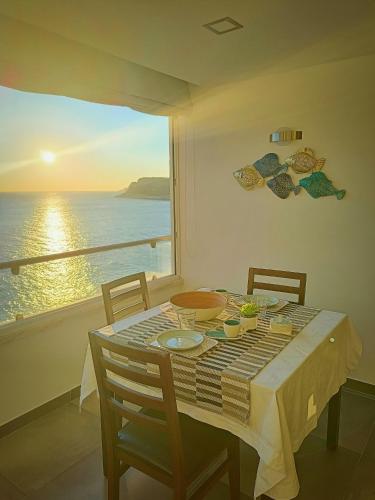 a dining room table with a view of the ocean at Acqua Marine in Sesimbra