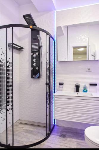 a bathroom with a shower with a phone on the wall at HF - Mamaia Nord Building Resort in Mamaia Sat/Năvodari