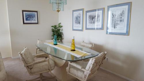 a dining room with a glass table and chairs at 1 Bedroom Condo with Amazing View in Pensacola Beach