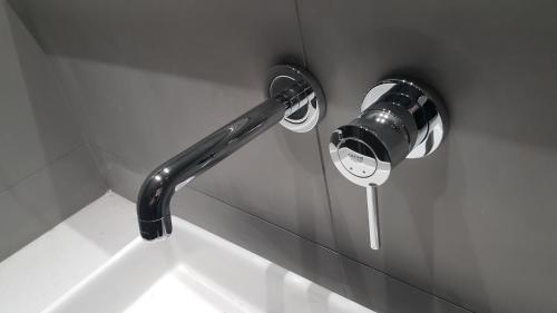 a shower head attached to the side of a wall at Castello City Hotel in Heraklio Town