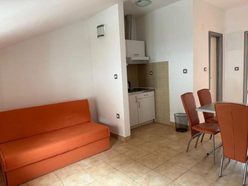 a living room with a couch and a table and chairs at Apartments Klara in Podaca
