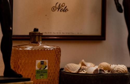 a bottle of iodine next to a basket of shells at La Cortese, cuore barocco in Noto