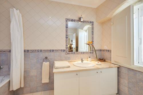 a bathroom with a sink and a mirror at Eugaria Country House by Lost Lisbon in Sintra