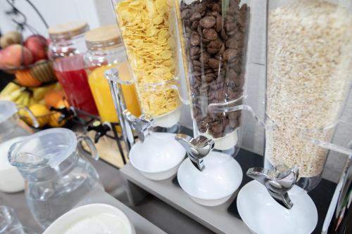 a counter with a bunch of food in vases at Hotel Dirista in Shkodër