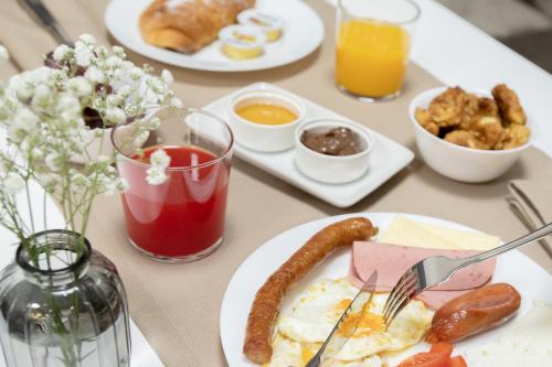 a table topped with plates of breakfast foods and drinks at Hotel Dirista in Shkodër