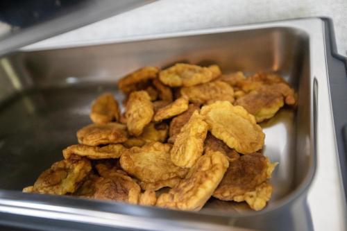 a container filled with fried food in a microwave at Hotel Dirista in Shkodër